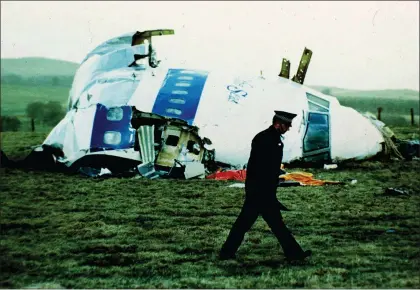  ?? MARTIN CLEAVER — THE ASSOCIATED PRESS FILE ?? A police officer walks by the nose of Pan Am flight 103 in a field near the town of Lockerbie, Scotland where it lay after a bomb aboard exploded, killing a total of 270people, Wednesday, Dec. 21, 1988. Authoritie­s in Scotland on Sunday, Dec. 11, 2022say the Libyan man suspected of making the bomb that destroyed a passenger plane over Lockerbie, Scotland, in 1988is in U.S. custody. Scotland’s Crown Office and Procurator Fiscal Service said in a statement that the families of those who died had been told the news.