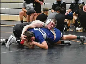  ??  ?? Covington’s Cael Vanderhors­t (top) wrestles at the 138-pound weight class.