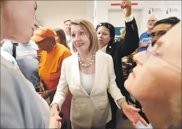  ?? Photograph­s by Wilfredo Lee Associated Press ?? MINORITY LEADER Nancy Pelosi is gracious with her admirers, but seems far more interested in the nuts and bolts of her job — passing legislatio­n and maximizing Democratic victories in congressio­nal campaigns.