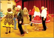  ?? Photos courtesy of Bill Allen ?? With skirts flying, couples square dance in Riordan Hall.