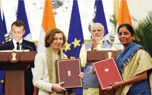  ??  ?? Prime Minister Narendra Modi and the President of the French Republic, Emmanuel Macron witnessing the exchange of agreements between Minister of the French Armed Forces Florence Parly and Defence Minister Nirmala Sitharaman in New Delhi on March 10, 2018