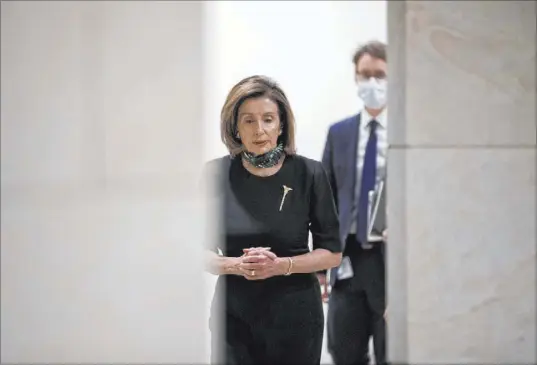  ?? Andrew Harnik The Associated Press ?? House Speaker Nancy Pelosi, D-Calif., arrives for a Thursday news conference on Capitol Hill. The House has approved a package of historic rules changes so Congress can keep functionin­g even while it’s partly closed.