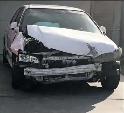  ?? The Associated Press ?? EXPLODING AIR BAGS: A 2002 Honda Accord involved in a March 3 crash in which an exploding Takata air bag inflator badly injured the driver, Karina Dorado, sits in a driveway Tuesday in Las Vegas. The incident has exposed a danger posed by the recalled...