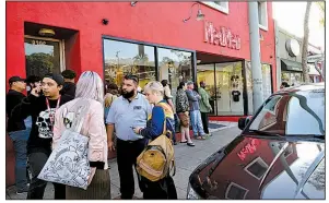  ?? AP file photo ?? Customers line up in January outside MedMen, a marijuana dispensary in West Hollywood, Calif. Marijuana businesses are lining up to go public on the Canadian Securities Exchange to tap into financing from investors put off by the U.S. government’s stance on the drug.