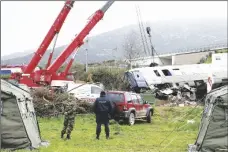  ?? AP PHOTO/VAGGELIS KOUSIORAS ?? Cranes remove debris after a collision in Tempe, about 376 kilometres (235 miles) north of Athens, near Larissa city, Greece, on Thursday.