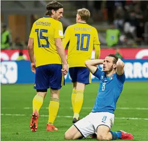  ??  ?? Not your day: Italy’s Alessandro Florenzi holding his head in disbelief after failing to score against Sweden in the 2018 World Cup playoff second-leg clash at the San Siro in Milan on Monday. — Reuters
