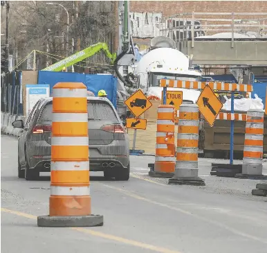  ?? JOHN MAHONEY / POSTMEDIA NEWS FILES ?? In Montreal, orange traffic cones have become a satirical civic emblem, given
their role in exacerbati­ng traffic congestion, Peter Shawn Taylor writes.