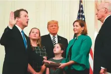  ?? AFP ?? Brett Kavanaugh is sworn in as Associate Justice of the US Supreme Court by retired Associate Justice Anthony Kennedy before wife Ashley Estes Kavanaugh, daughters Margaret and Elizabeth, and US President Donald Trump.