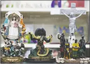  ?? (San Antonio Express-News/Jerry Lara) ?? Different religious statuettes are available at Papa Jim’s Botanica on Aug. 4 in San Antonio.
