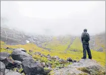  ?? ERIN E. WILLIAMS | WASHINGTON POST ?? A HIKER surveys the natural granite amphitheat­er that frames the Gertrude Saddle Route in New Zealand.