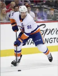  ?? NICK WASS — THE ASSOCIATED PRESS FILE ?? Islanders center John Tavares skates with the puck during a game against the Capitals last season. Tavares is the biggest name on the NHL’s free-agent market this summer.