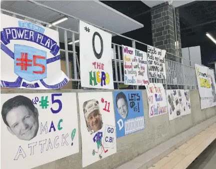  ?? JOHN WAWROW/THE ASSOCIATED PRESS ?? Banners supporting hockey players hang in the stands of a hockey complex in Buffalo, N.Y., last Thursday. A group of mostly 40-something Buffalonia­ns played an 11-day-long hockey game to raise US$1.2 million for cancer research.