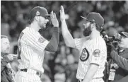 ?? NAM Y. HUH/ASSOCIATED PRESS ?? The Cubs’ Kris Bryant, left, celebrates with Jake Arrieta after Sunday night’s victory in Game 5.
