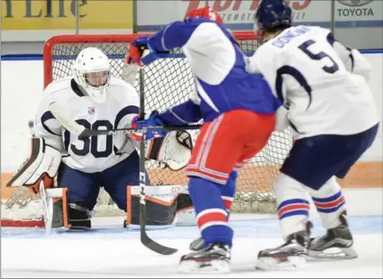  ?? DAVID BEBEE, RECORD STAFF ?? Kitchener Rangers goalie hopeful Lucas Pfeil makes a save for Team Blue while playing in a scrimmage at training camp Tuesday.