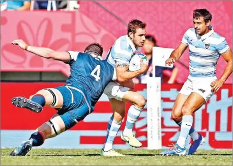  ?? ODD ANDERSEN/AFP ?? Argentina fly-half Nicolas Sanchez (centre) is tackled by US lock Nate Brakeley as scrum-half Felipe Ezcurra watches during the Japan 2019 Rugby World Cup Pool C match at the Kumagaya Rugby Stadium in Kumagaya on Wednesday.