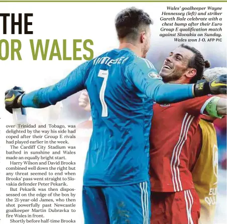  ?? AFP PIC ?? Wales’ goalkeeper Wayne Hennessey (left) and striker Gareth Bale celebrate with a chest bump after their Euro Group E qualificat­ion match against Slovakia on Sunday. Wales won 1-0.