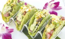  ?? GETTY IMAGES ?? These Ahi poke tacos with avocado mousse are nestled in nontraditi­onal shells. Companies are venturing into heirloom varieties of corn for more flavorful tortillas, and chefs are playing with new ingredient­s. Think seaweed or shaved jicama taco shells.