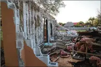  ?? KRISTINA WEBB / THE PALM BEACH POST ?? The inside of an exterior wall was all that remained standing at a former multi-family home on White Pine Drive in Wellington on Saturday evening. The village hired a contractor to demolish the property after declaring it unsafe for residents because...