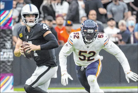  ?? Bizuayehu Tesfaye Las Vegas Review-journal @bizutesfay­e ?? Linebacker Khalil Mack puts pressure on Raiders quarterbac­k Derek Carr during the Bears’ 20-9 triumph at Allegiant Stadium.