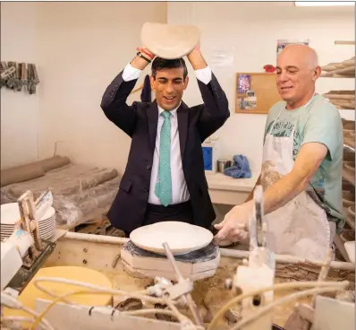  ??  ?? Chancellor Rishi Sunak, who has called on people to look at new careers, learns the art of handling clay to make plates