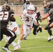  ?? Brian A. Pounds/Hearst Connecticu­t Media ?? St. Joseph’s Jesse Covino runs for yards against the Stamford defense during the first half at Boyle Stadium in Stamford on Saturday.