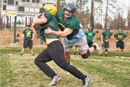  ?? Photos by Scott Strazzante / The Chronicle ?? Top: During football practice at Paradise High, Ashton Wagner tackles RJ Young as the team prepares for the first challenge in their ultimate quest for a state championsh­ip.