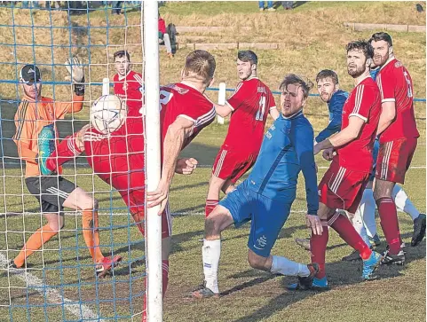  ??  ?? Dougie Cameron’s corner is missed by both friend and foe as the ball makes its way into the Sauchie net for a Lochee goal.