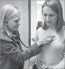  ?? Associated Press photo ?? In this photo provided by the University of Washington, Dr. Linda Vorvick examines Heather VanDusen at UW Neighborho­od Clinic in Seattle. When emergency tests showed the telltale right-sided pain in VanDusen's abdomen was appendicit­is, she figured she’d be quickly wheeled into surgery. But doctors offered her the option of antibiotic­s instead.