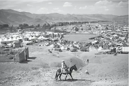  ??  ?? n LEFT: A Berber farmer rides his donkey Sept. 22 at the annual festival of Imilchil in Morocco’s Atlas mountains. What started as an annual marriage festival has become an economic boon for the tiny Berber village tucked into in the foothills of...