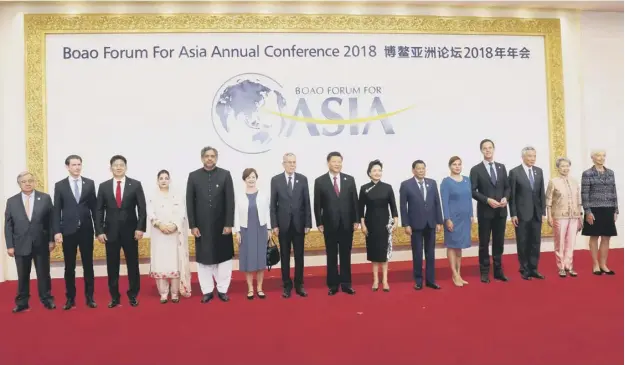  ?? PICTURE; GETTY ?? 0 China’s President Xi Jinping, centre, and his wife pose for pictures with leaders attending the Boao Forum for Asia (BFA) Annual Conference