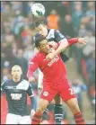  ??  ?? Millwall’s Sean St Ledger, (top), competes with Wigan Athletic’s Jean Beausejour during their English FACup semifinal soccer match at Wembley Stadium in London, April 13. (AP)