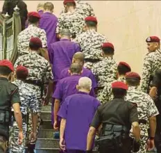  ?? PIC BY MOHD FADLI HAMZAH ?? Some of the Lahad Datu incursion terrorists being escorted by security personnel at the Court of Appeal in Putrajaya yesterday.