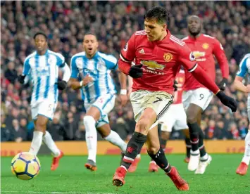  ?? — AFP ?? Manchester United’s Alexis Sanchez scores in their English Premier League match against Huddersfie­ld Town at Old Trafford on Saturday. United won 2- 0.