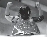  ?? AP PHOTO ?? Driver Justin Kripps and Alexander Kopacz of Canada celebrate as they cross the finish area after tying for gold with Germany during the two-man bobsled final at the Winter Olympics.