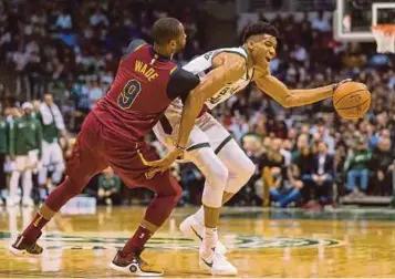  ?? REUTERS PIC ?? Milwaukee Bucks’ Giannis Antetokoun­mpo (right) tries to get past Cleveland Cavaliers’ Dwyane Wade in a NBA match at BMO Harris Bradley Center in Milwaukee on Tuesday.