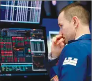  ?? The Associated Press/RICHARD DREW ?? Specialist Stephen Naughton works Monday on the floor of the New York Stock Exchange where stock prices slid on worries about trade tensions with China and news about technology companies.