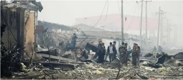  ??  ?? File photo shows Afghan security forces inspecting the site of a car bomb attack in Kabul, Afghanista­n. — Reuters photo