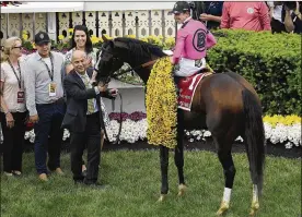  ?? NICK WASS / ASSOCIATED PRESS ?? Jockey Tyler Gaffalione sits aboard War of Will as trainer Mark Casse holds the reins after winning the Preakness Stakes horse race at Pimlico Race Course on Saturday in Baltimore.