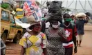  ?? Photograph: Pius Utomi Ekpei/AFP via Getty Images ?? People wear face masks in compliance with state rules in Ojodu-Berger, Lagos, Nigeria.