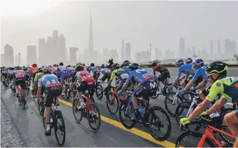  ?? AFP ?? Cyclists had to ride through sandy conditions during Stage 4 of the UAE Tour