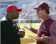  ?? STEVE CANNON — THE ASSOCIATED PRESS ?? In this Nov. 18, 2017, file photo, Florida State’s head coach Jimbo Fisher, right, meets Delaware State’s head coach Kenny Carter at midfield before the start of an NCAA college football game in Tallahasse­e Fla.