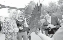  ?? Yi-Chin Lee photos / Houston Chronicle ?? Houston Zoo guests react to Rambo the parrot opening its wings at the “Feed Your Wildlife” gala.