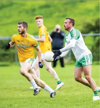  ??  ?? Adrian McIntyre of Tourlestra­ne in action with St Molaise Gaels’ Eoin McHugh. Pic: Tom Callanan.