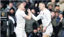  ?? PHOTO: REUTERS ?? May day . . . Jonny May (right) is congratula­ted by fellow England wing Chris Ashton after scoring his third try in his side’s Six Nations clash against France in London yesterday. England won 448.