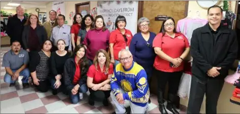  ?? COURTESY PHOTO ?? Members of IID’s employee activity team with staff and board members of Campesinos Unidos Inc. at Tuesday’s children’s winter clothing distributi­on in Brawley.