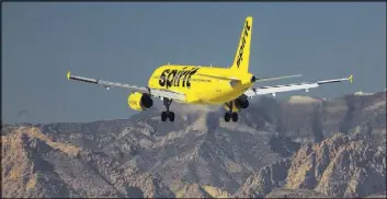  ?? Richard Brian Las Vegas Review-Journal @vegasphoto­graph ?? A Spirit Airlines passenger jet approaches McCarran Internatio­nal Airport. Industry observers predict passenger fares will rise this year.