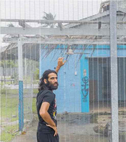  ??  ?? Behrouz Boochani outside the abandoned naval base on Manus Island, where he and other asylumseek­ers were locked up for the first three years.