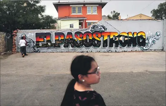  ?? Mario Tama Getty Images ?? AFTER an Aug. 3 shooting targeted Latinos and left 22 people dead, artists Gabe Vasquez and Justin Martinez painted an “El Paso Strong” mural in the Texas city.