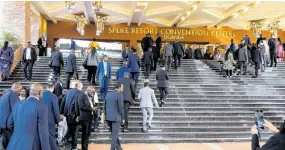  ?? AP PHOTOS ?? Delegates walk outside Speke resort convention centre during the 19th Summit of Heads of State and Government of the Non-Aligned Movement (NAM) in Kampala, Uganda Friday, January 19.