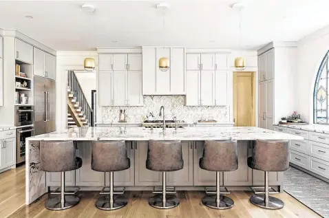  ?? Photos by Colleen Scott Photograph­y ?? Laura Manchee is tired of all-white kitchens, so she painted her cabinets Benjamin Moore's Stonington Gray from its Historic Color Collection.